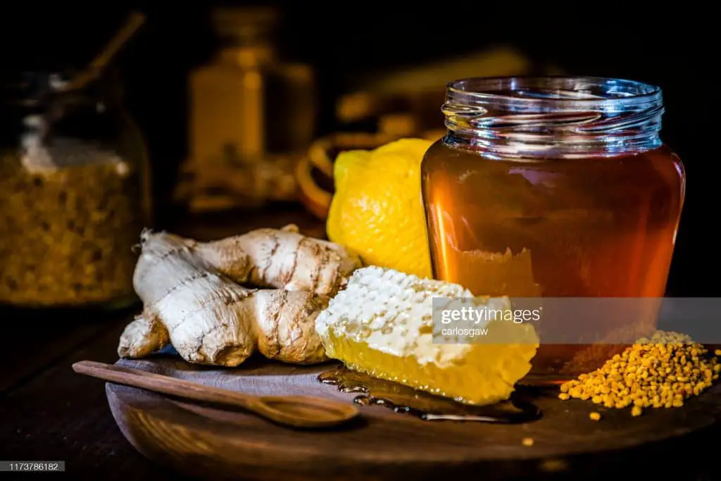 Honey jar surrounded by other ingredients