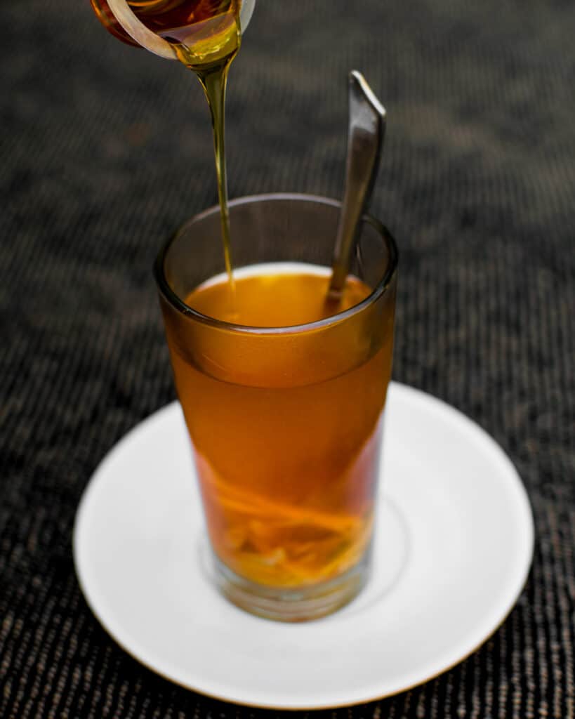 honey dripping into tea
