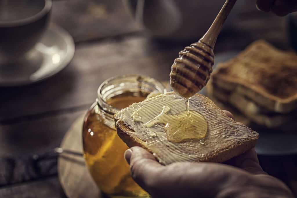 honey dripping onto bread